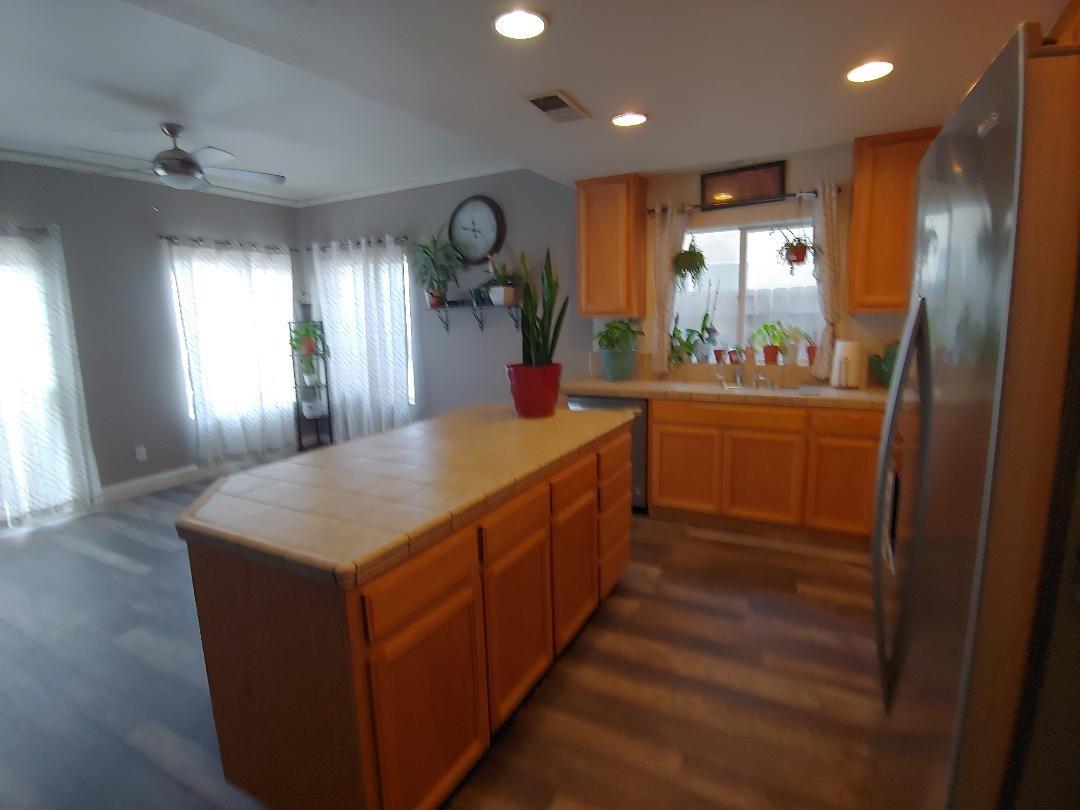1190 Hazelnut Lane Madera, CA 93637 - Photo 7 of 18 a kitchen with stainless steel appliances granite countertop a sink a counter space and a window