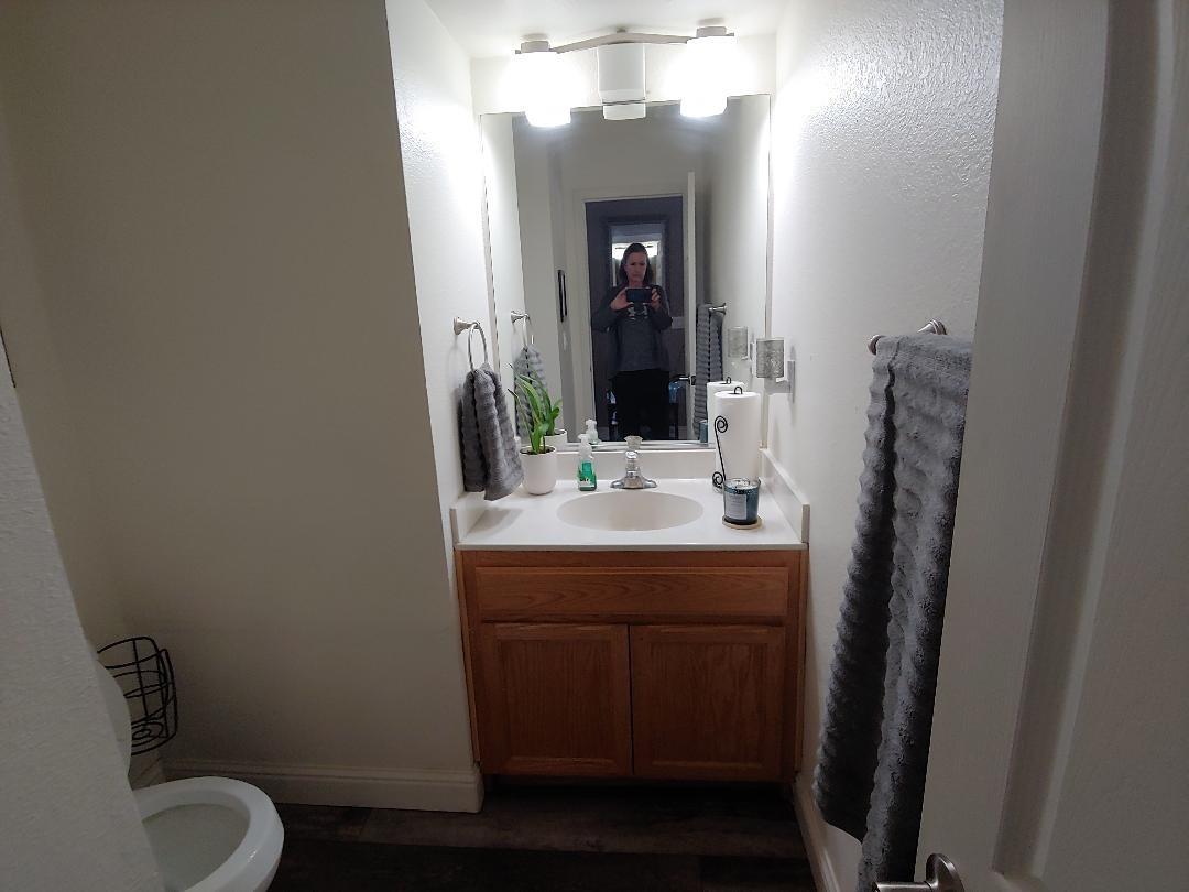 1190 Hazelnut Lane Madera, CA 93637 - Photo 8 of 18 a bathroom with a toilet sink and mirror