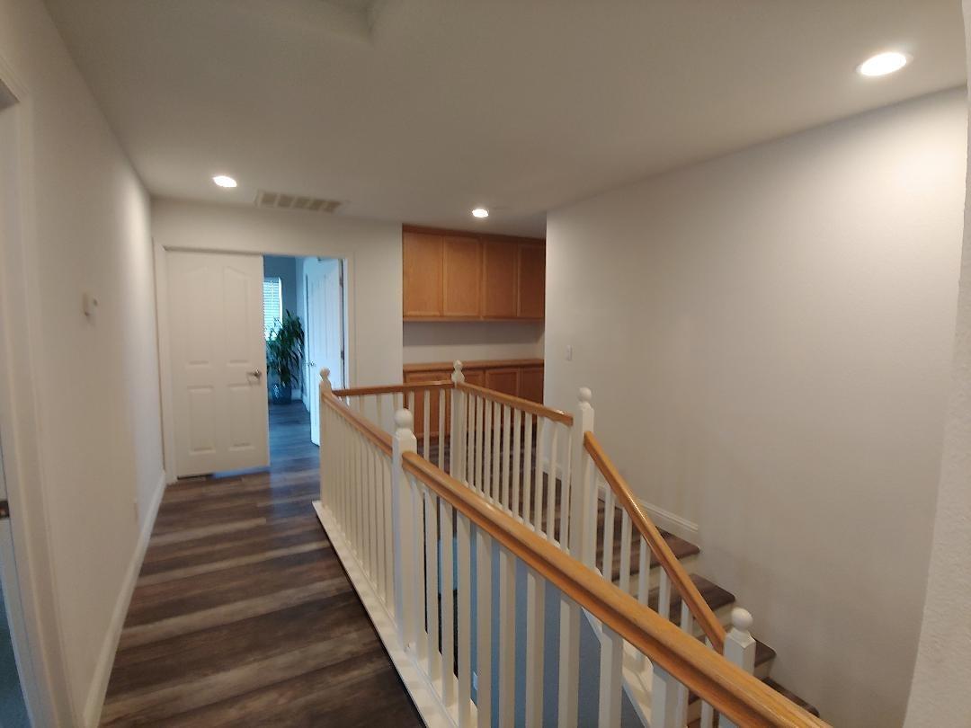 1190 Hazelnut Lane Madera, CA 93637 - Photo 9 of 18 a view of a hallway with wooden floor and stairs