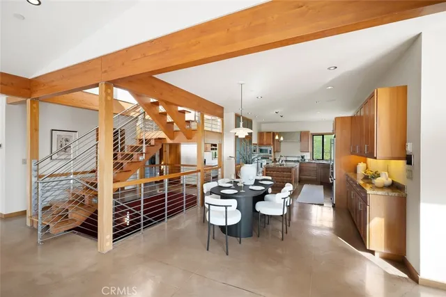a dining room with furniture water view and a floor to ceiling window