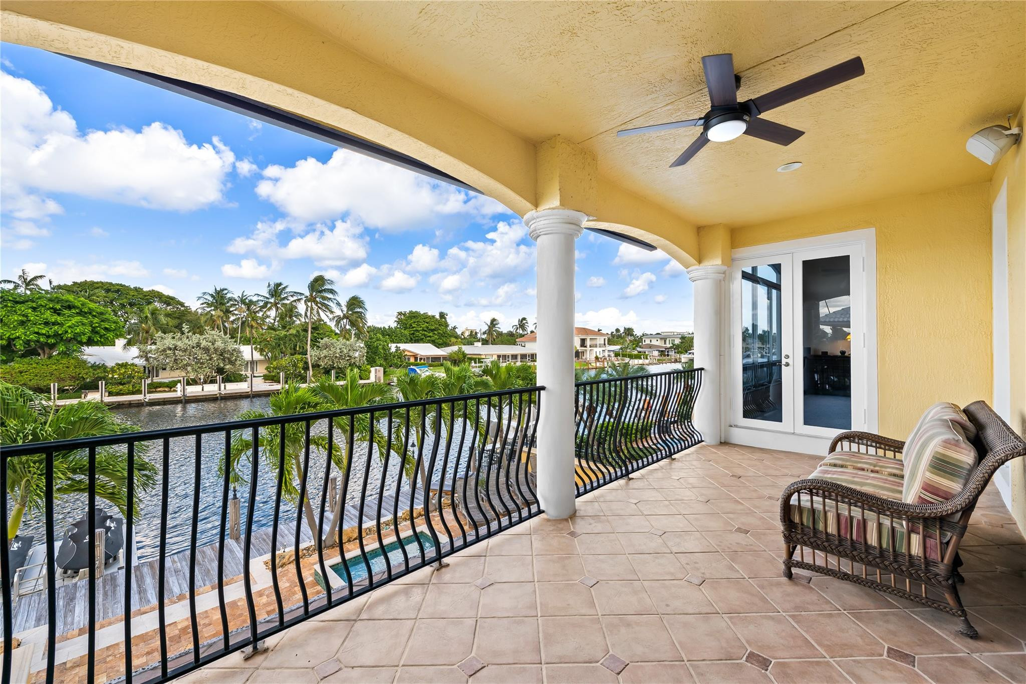 2637 Northeast 28th Court Lighthouse Point, FL 33064 - Photo 13 of 50 a porch with a table in balcony