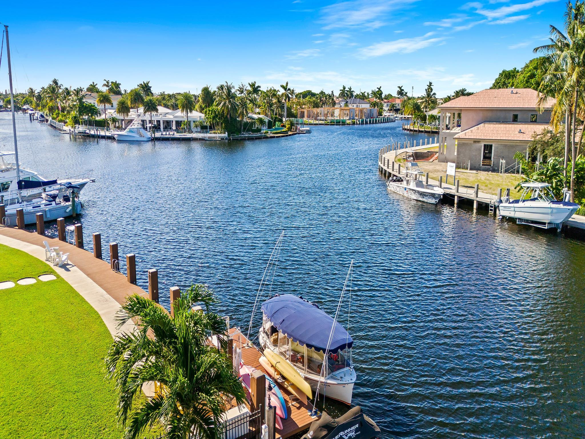 2637 Northeast 28th Court Lighthouse Point, FL 33064 - Photo 45 of 50 a view of a lake with boats and trees in the background
