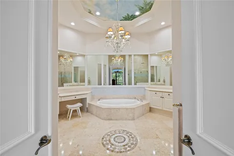 a bathroom with a tub sink shower and mirror