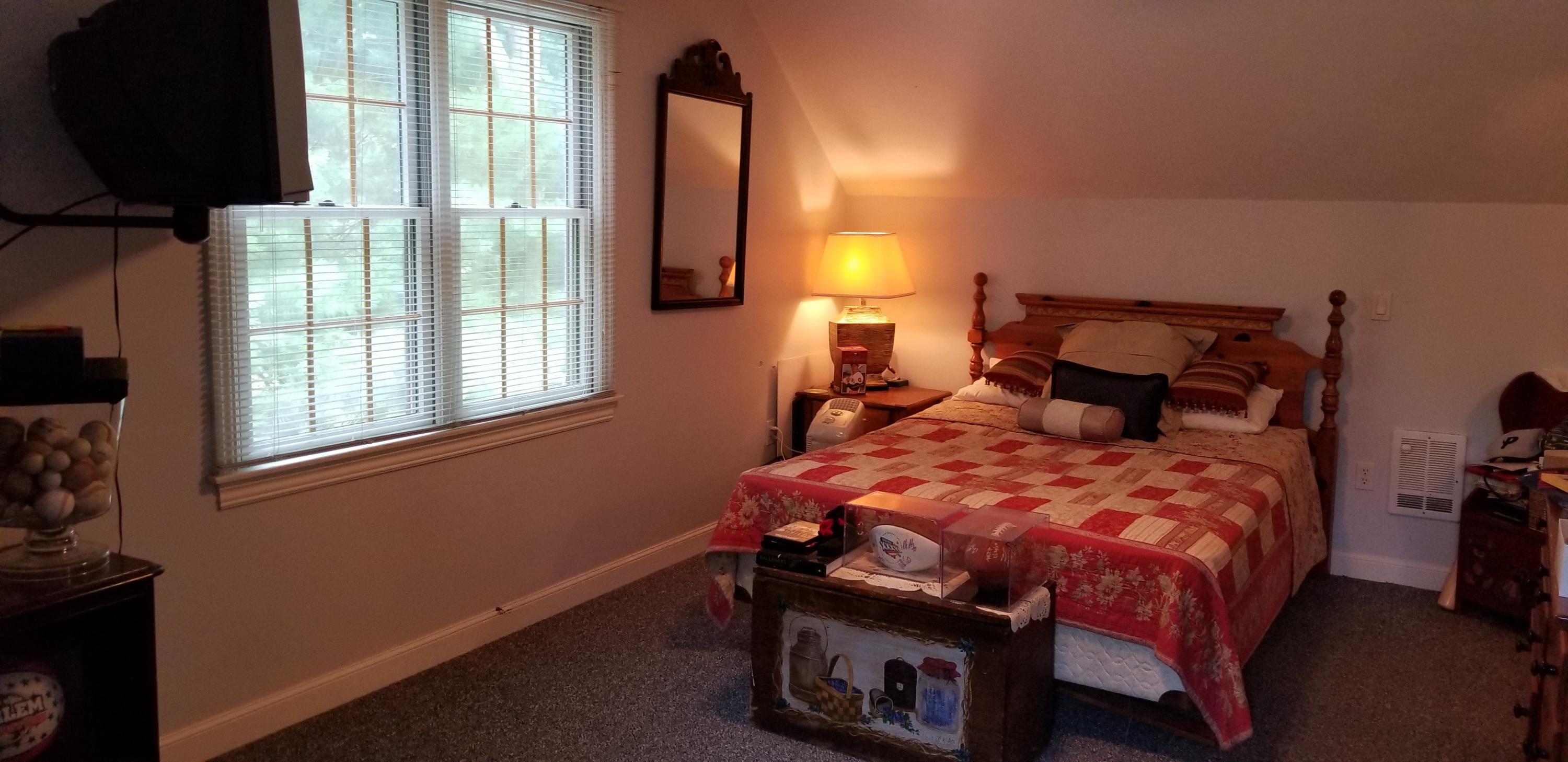 7 Penelope Road Monument Beach, MA 02532 - Photo 19 of 31 a bedroom with a bed a mirror and a window