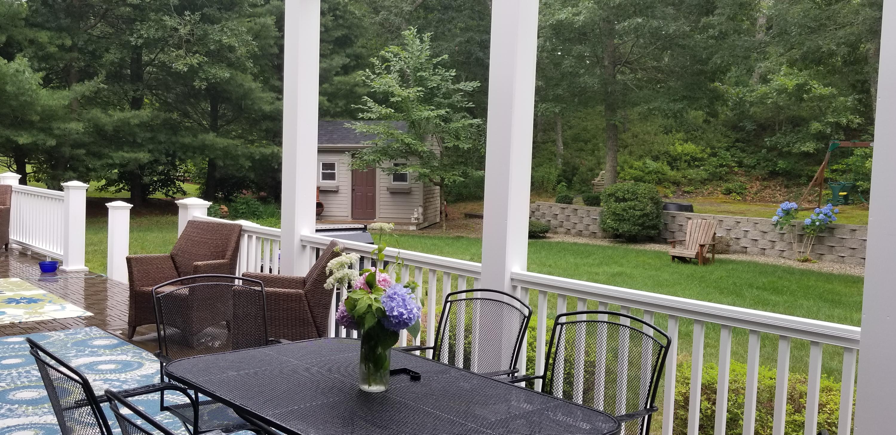 7 Penelope Road Monument Beach, MA 02532 - Photo 21 of 31 a view of a patio with table and chairs and wooden floor
