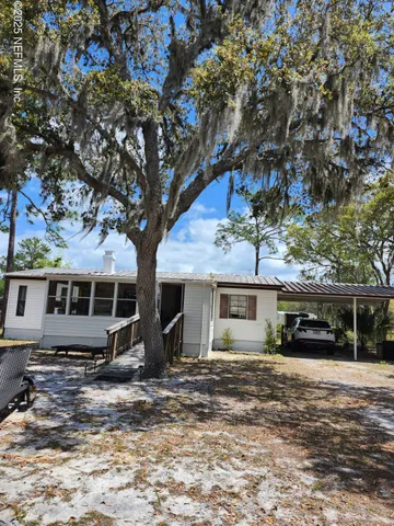 front view of a house with a tree