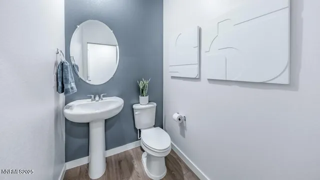 a bathroom with a sink a mirror a toilet and a mirror