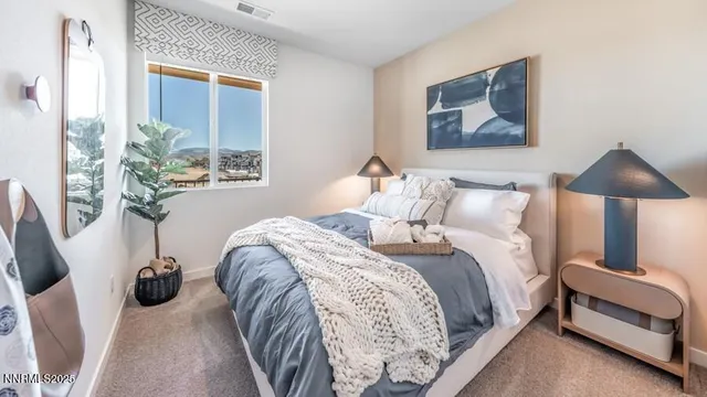 a bedroom with a bed and a painting on the wall