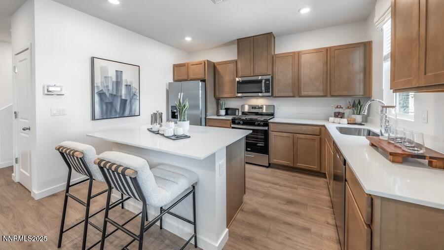 1031 Middle Gate Road Carson City, NV 89701 - Photo 4 of 29 a kitchen with stainless steel appliances granite countertop a sink a stove a refrigerator cabinets and chairs