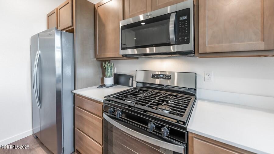 1031 Middle Gate Road Carson City, NV 89701 - Photo 9 of 29 a kitchen with stainless steel appliances granite countertop a stove and a microwave