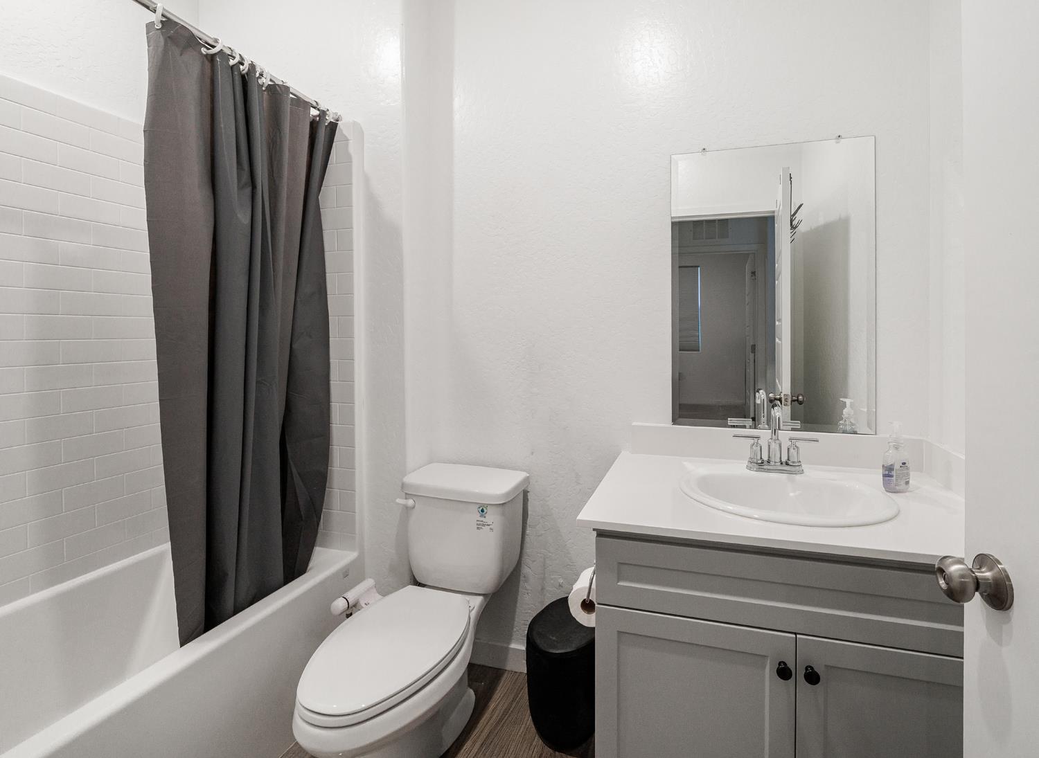 2735 North Redda Road Fresno, CA 93737 - Photo 11 of 20 a bathroom with a sink a toilet a mirror and shower