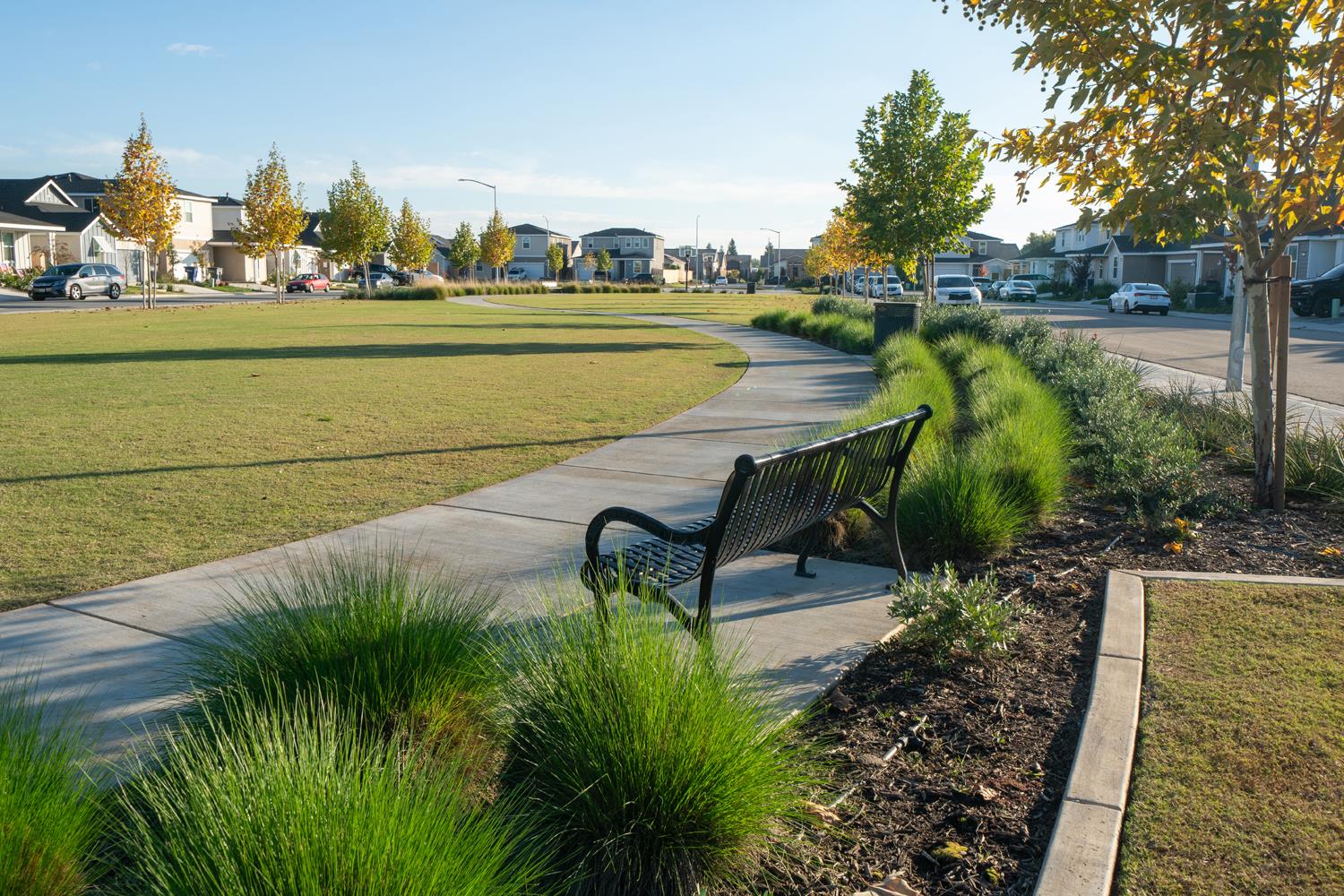 2735 North Redda Road Fresno, CA 93737 - Photo 19 of 20 a view of a lake with a table and chairs in the patio