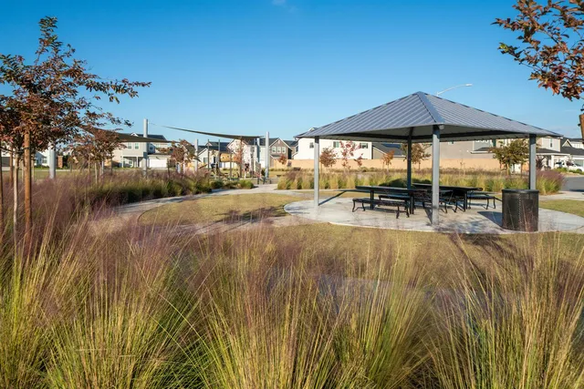 a view of a patio with table and chairs under an umbrella