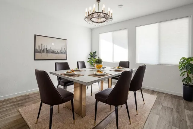 a view of a dining room with furniture window and wooden floor