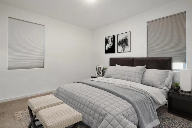 a bed room with a bed and a chair