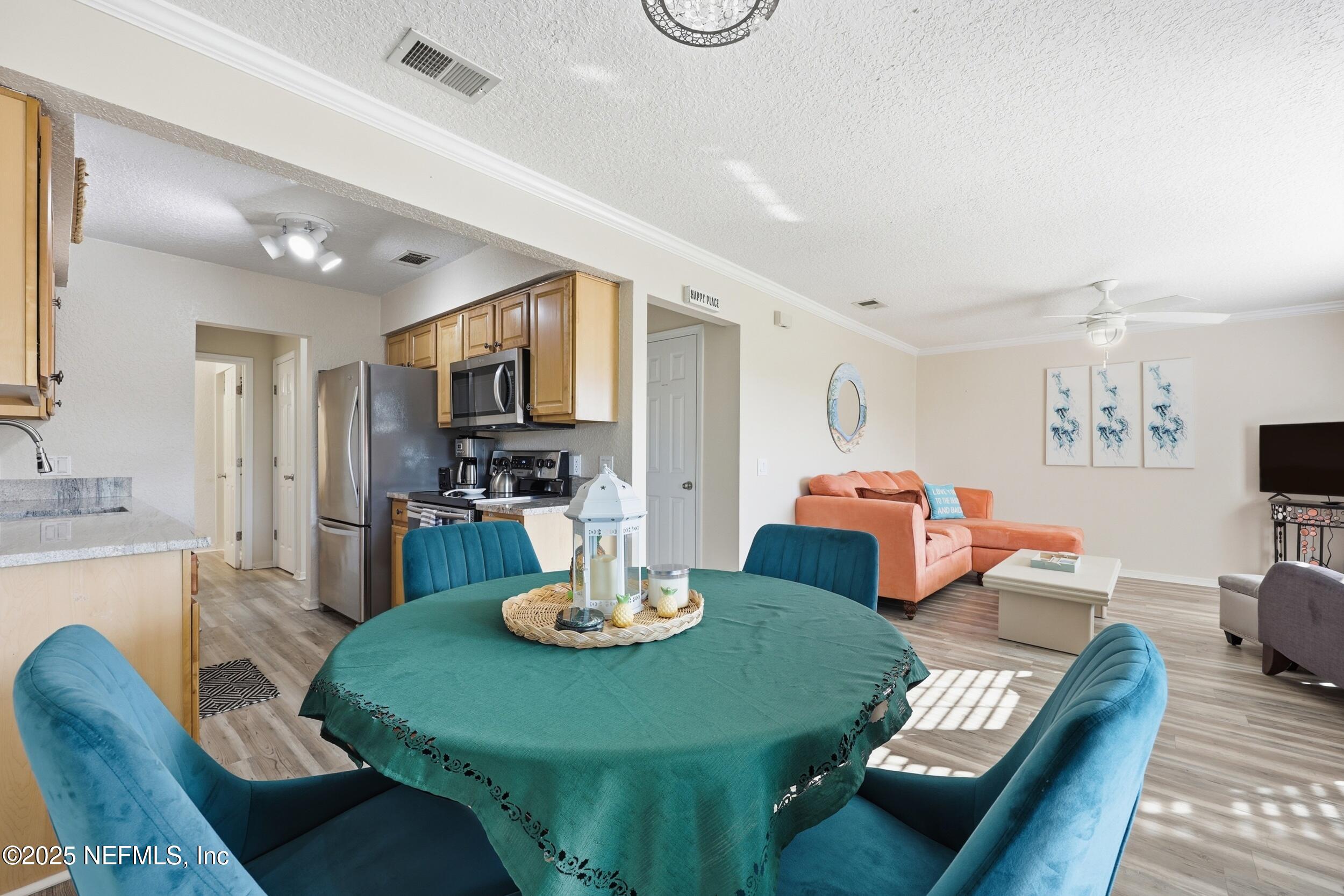 47 Clipper Court St. Augustine, FL 32080 - Photo 14 of 50 a view of a dining room with furniture a chandelier and wooden floor