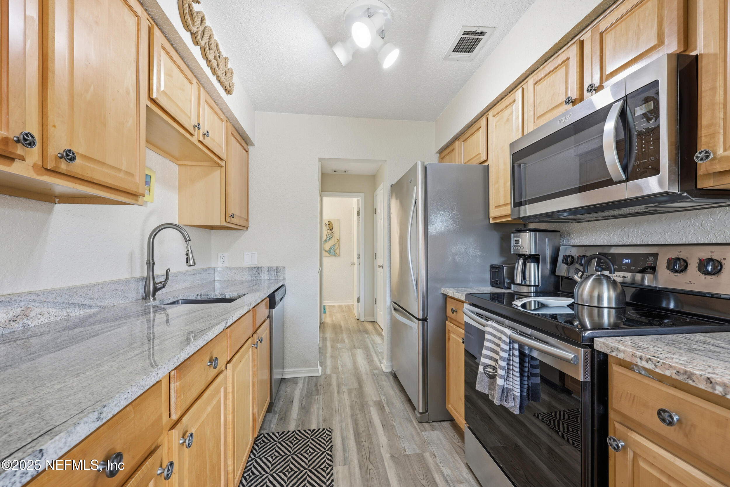 47 Clipper Court St. Augustine, FL 32080 - Photo 15 of 50 a kitchen with stainless steel appliances granite countertop a sink and a stove