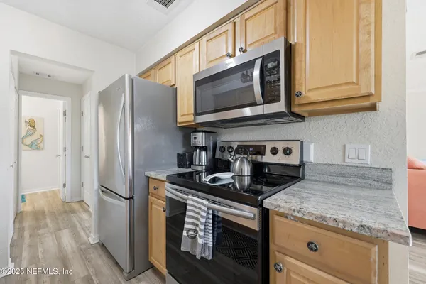 a kitchen with granite countertop a sink and cabinets