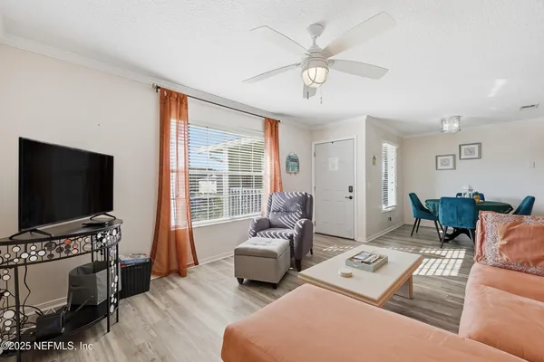 a living room with furniture a rug and a large window