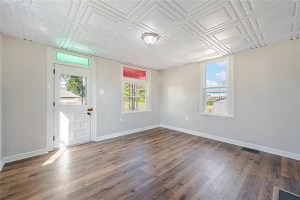 wooden floor in an empty room with a window