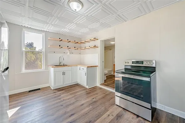 a kitchen with granite countertop a stove and a refrigerator