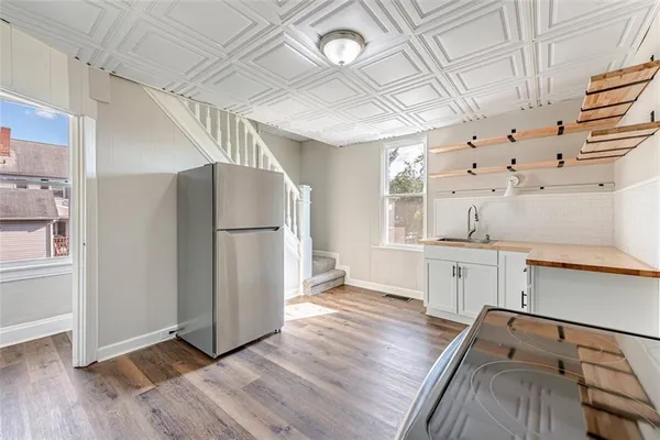 a kitchen with stainless steel appliances a refrigerator and a stove top oven