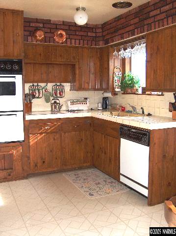 978 Lester Avenue Reno, NV 89502 - Photo 4 of 7 a kitchen with a sink window and cabinets