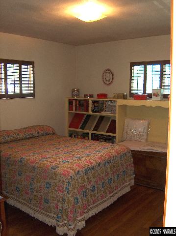 978 Lester Avenue Reno, NV 89502 - Photo 5 of 7 a bedroom with a bed and a chandelier