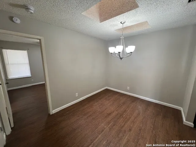 a view of a room with wooden floor and fan