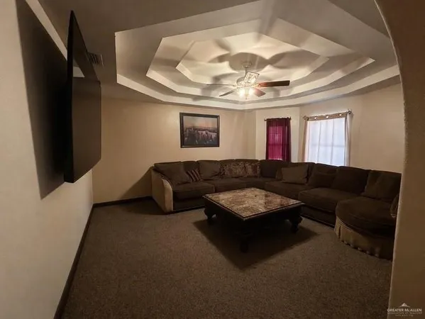 a living room with furniture and a chandelier