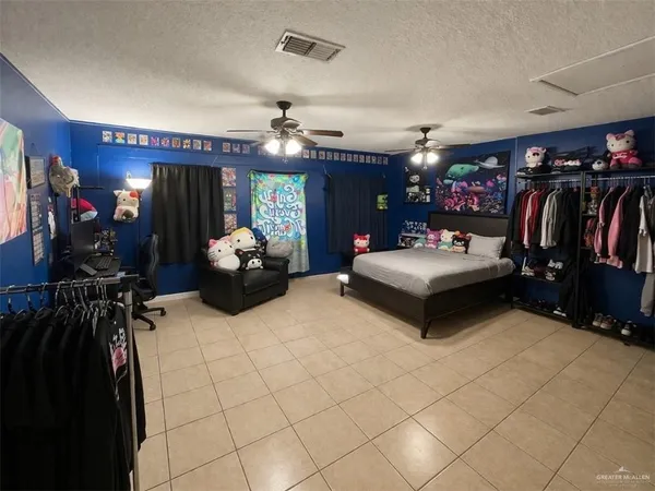 a living room with furniture a flat screen tv and gym equipment