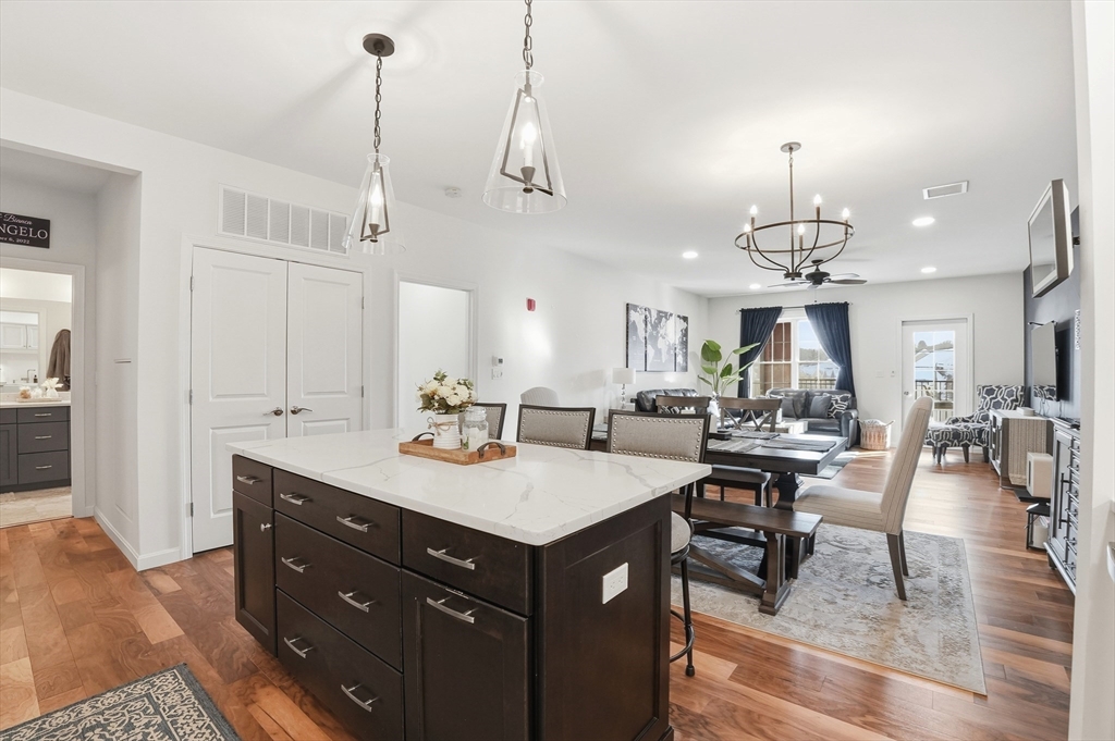 a living room with stainless steel appliances kitchen island granite countertop furniture and a view of living room