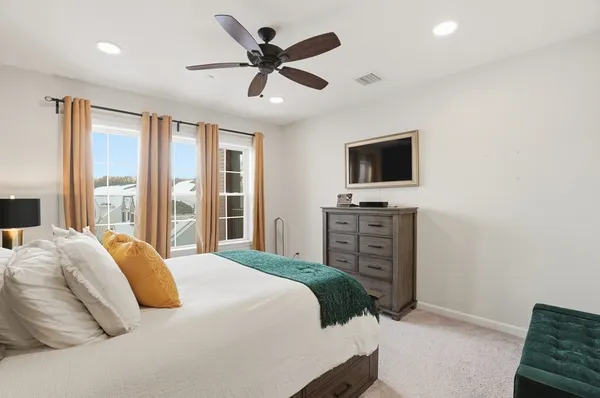 a bedroom with a balcony a bed and a flat screen tv