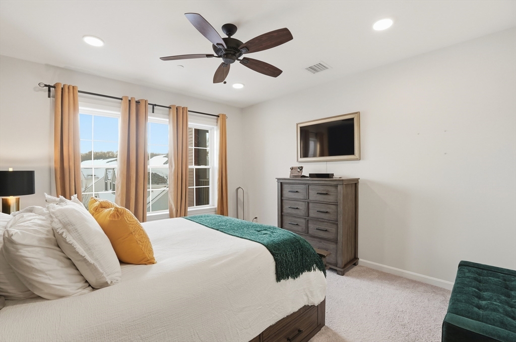 15 Revolution Way, Unit 2205 Canton, MA 02021 - Photo 13 of 34 a bedroom with a balcony a bed and a flat screen tv