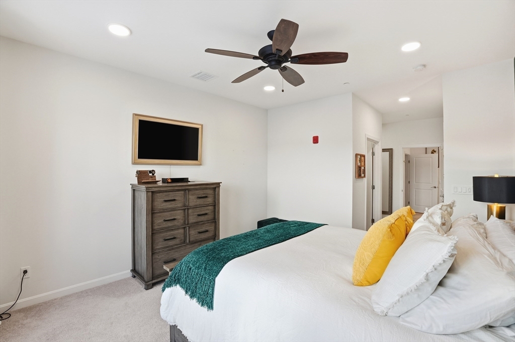 15 Revolution Way, Unit 2205 Canton, MA 02021 - Photo 14 of 34 a bedroom with a bed and a flat screen tv