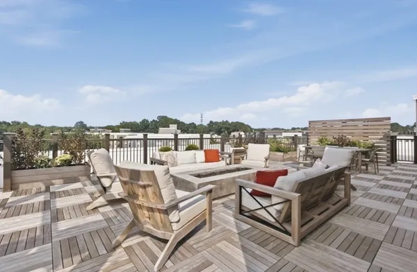 a view of a patio with table and chairs with wooden floor and fence
