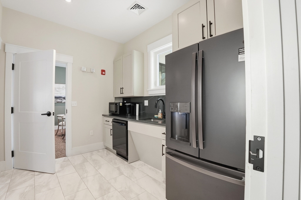 15 Revolution Way, Unit 2205 Canton, MA 02021 - Photo 31 of 34 a kitchen with stainless steel appliances a refrigerator and a sink