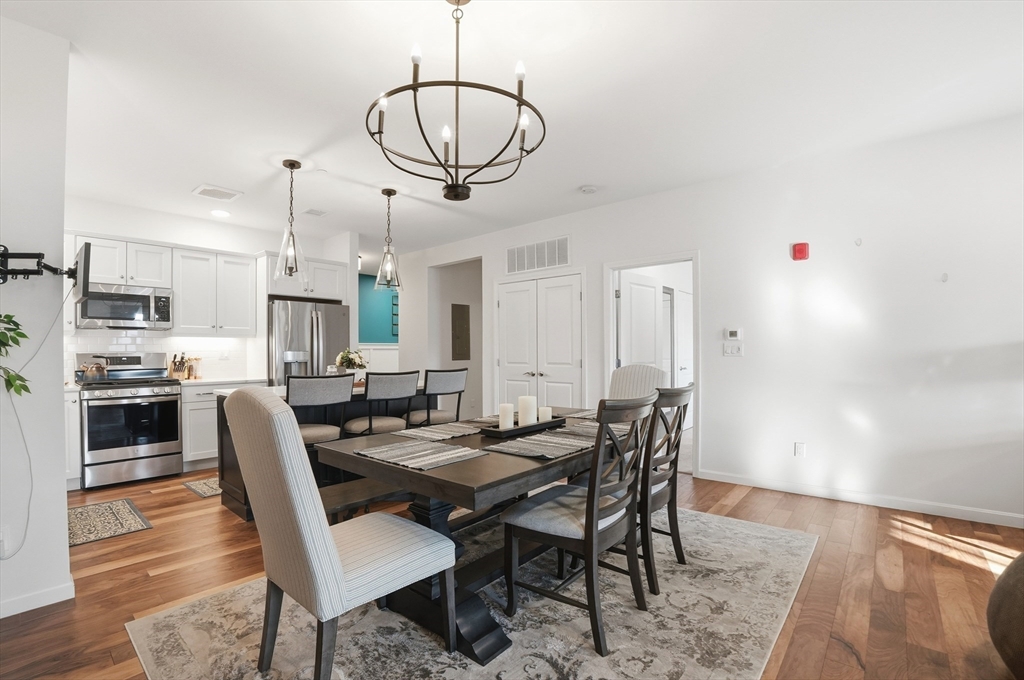 15 Revolution Way, Unit 2205 Canton, MA 02021 - Photo 6 of 34 a view of a dining room with furniture