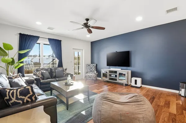 a bedroom with furniture and a flat screen tv