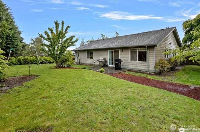 a front view of a house with yard and green space