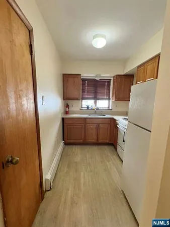 a kitchen with stainless steel appliances a refrigerator and a sink