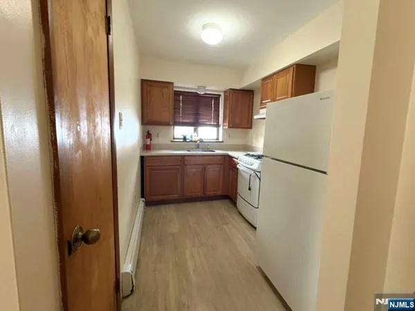 a kitchen with stainless steel appliances a refrigerator and a stove