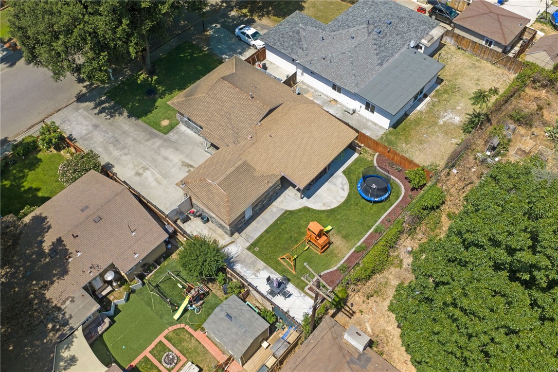 4869 Serrano Place Riverside, CA 92504 - Photo 9 of 40 Overhead view showing the home’s spacious footprint, wide concrete parking area, and nicely planned outdoor living spaces.