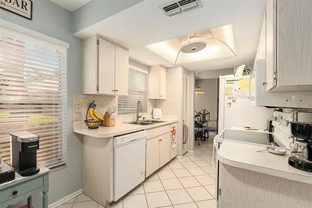 a kitchen with a sink cabinets and window