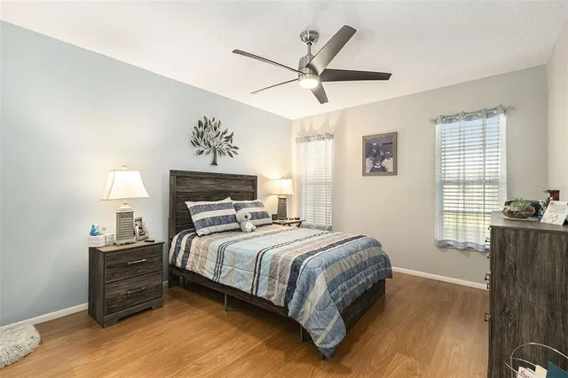 a bedroom with a bed a window and a chandelier