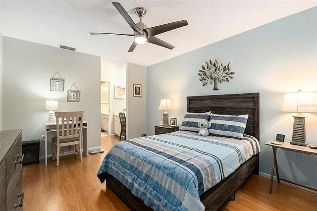 a bedroom with a large bed and a chandelier
