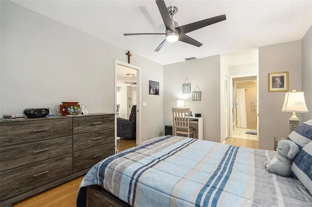 a bedroom with a bed and a chandelier