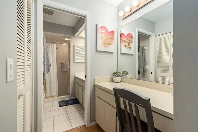 a bathroom with a sink vanity and a mirror