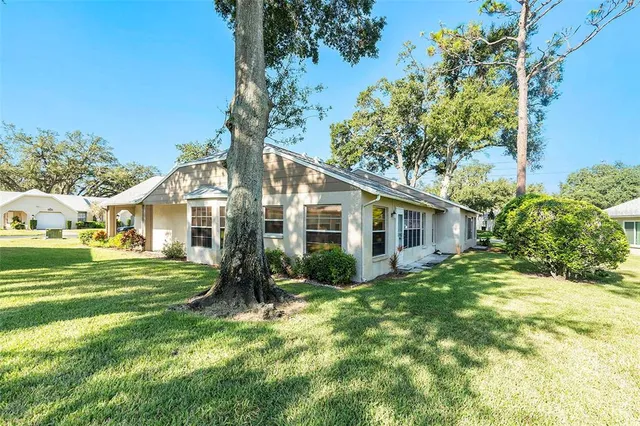 a front view of house with yard and green space