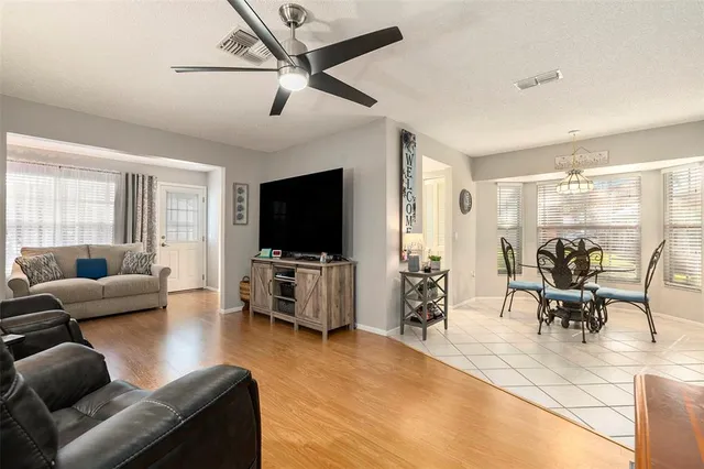 a living room with furniture and a flat screen tv with wooden floor